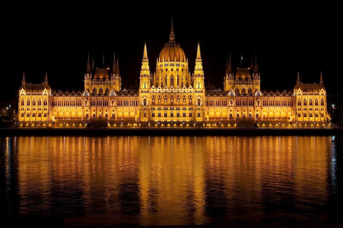 Parliament building in Budapest lit up at night. 