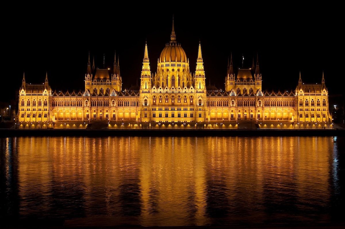 Parliament building in Budapest lit up at night.