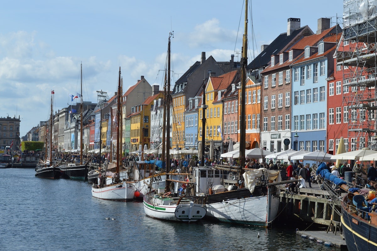 Riverside by Denmark. Colorful houses and boats can be seen along the river. 