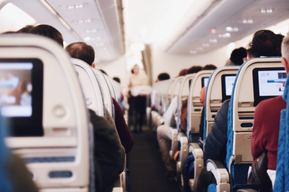 Airline cabin with passengers looking at their screens