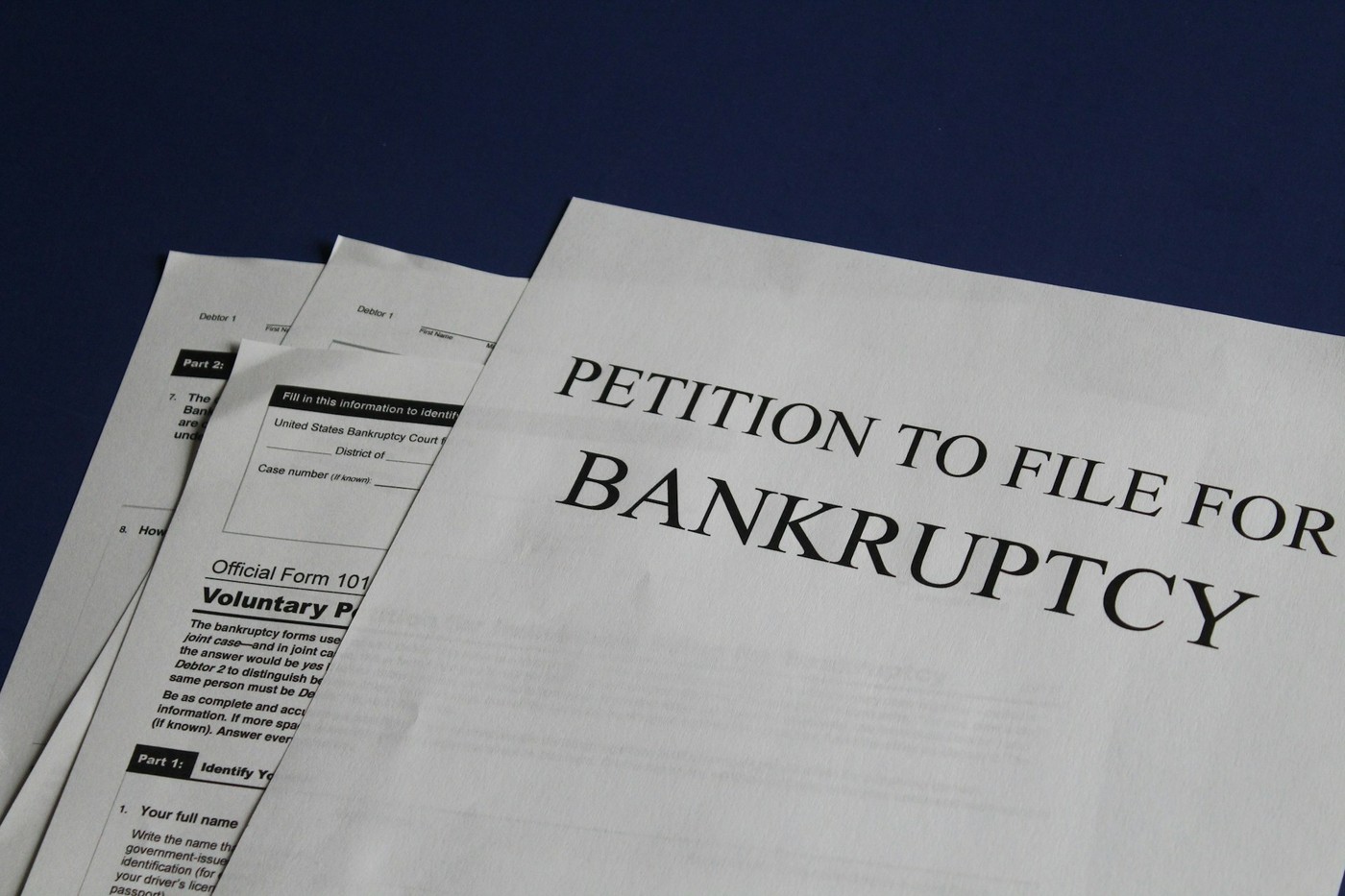 Papers reading "Petition to file for bankruptcy"