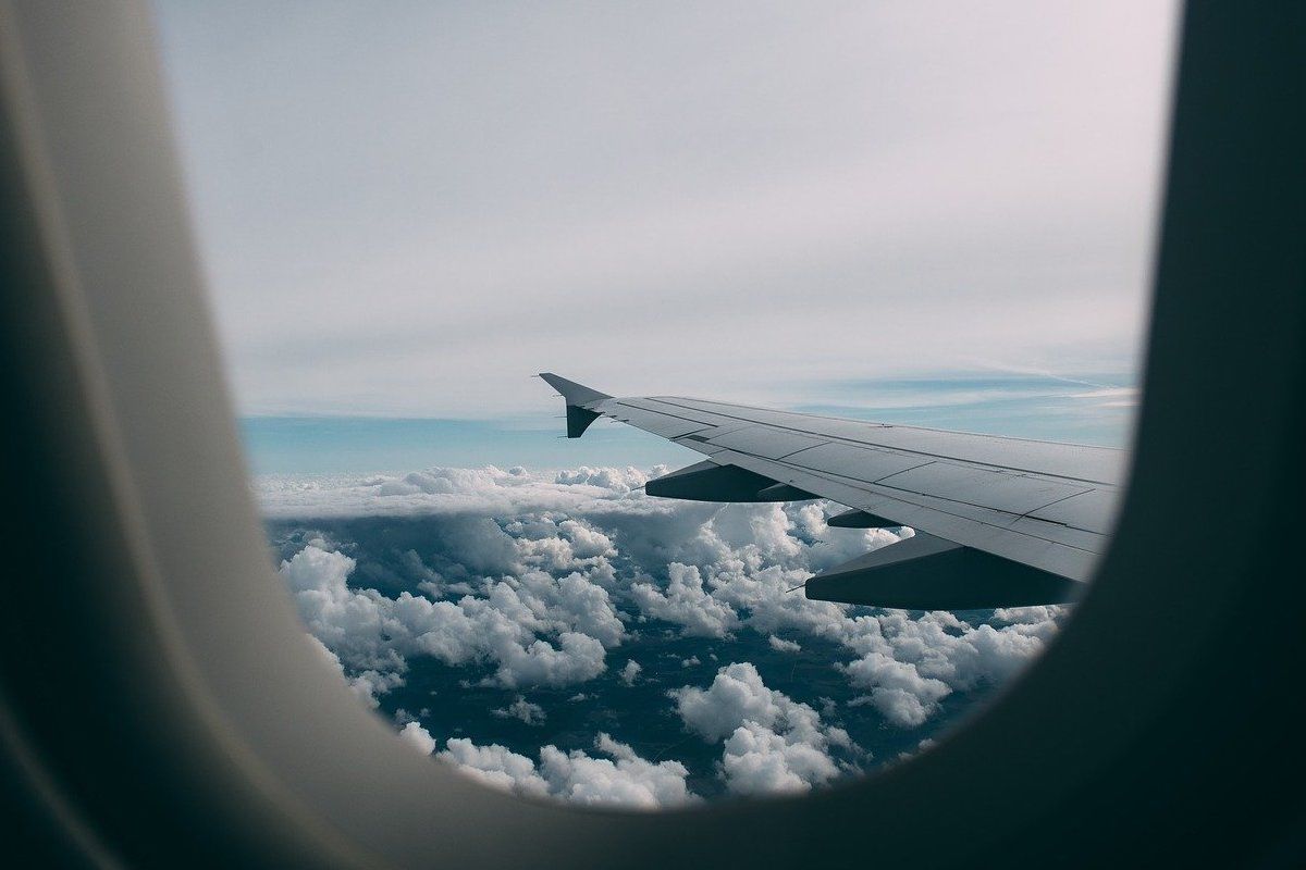 Airplane window showing view from the clouds