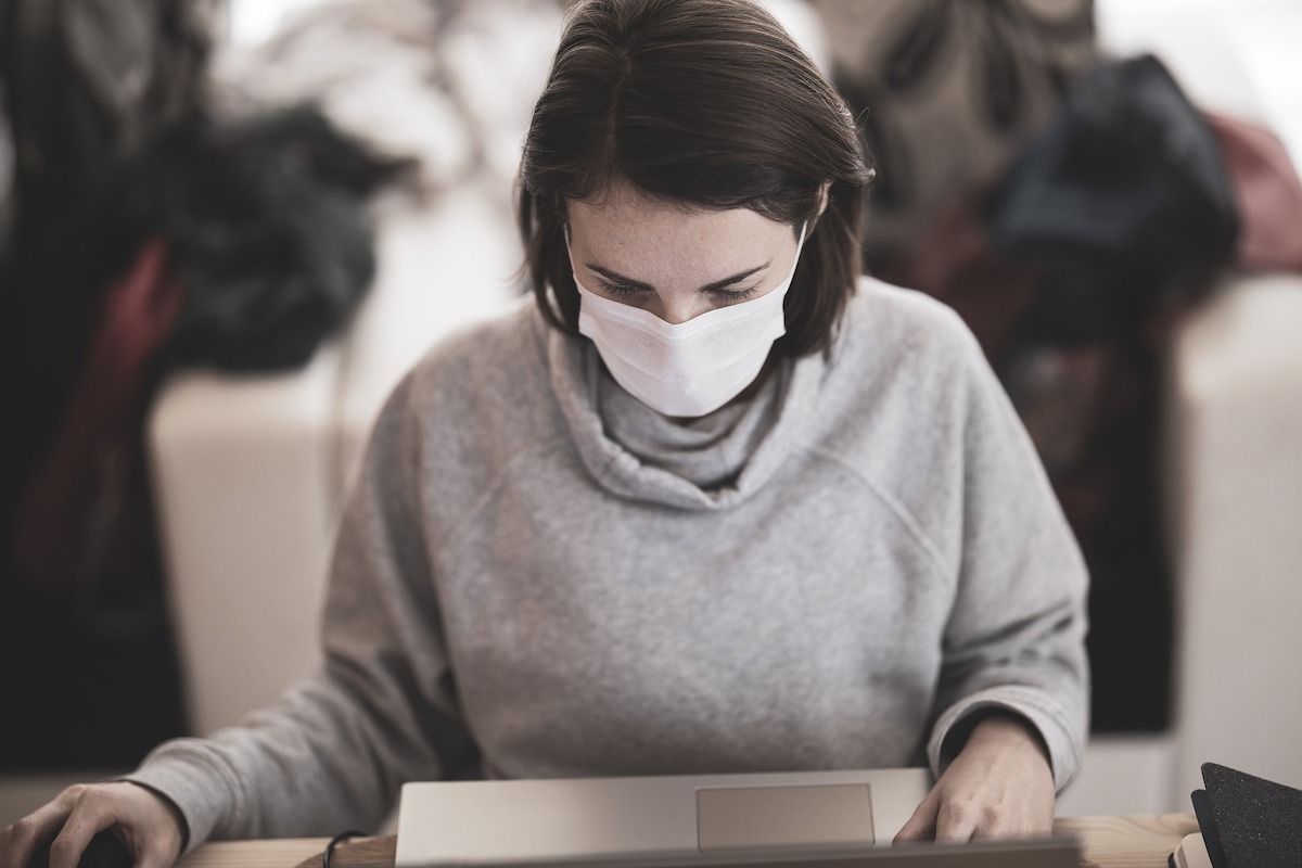 Woman checking vaccine passport requirements online