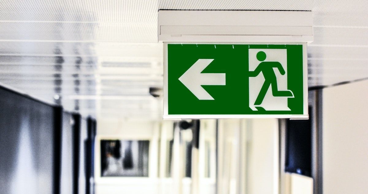 Exit sign in a white hallway
