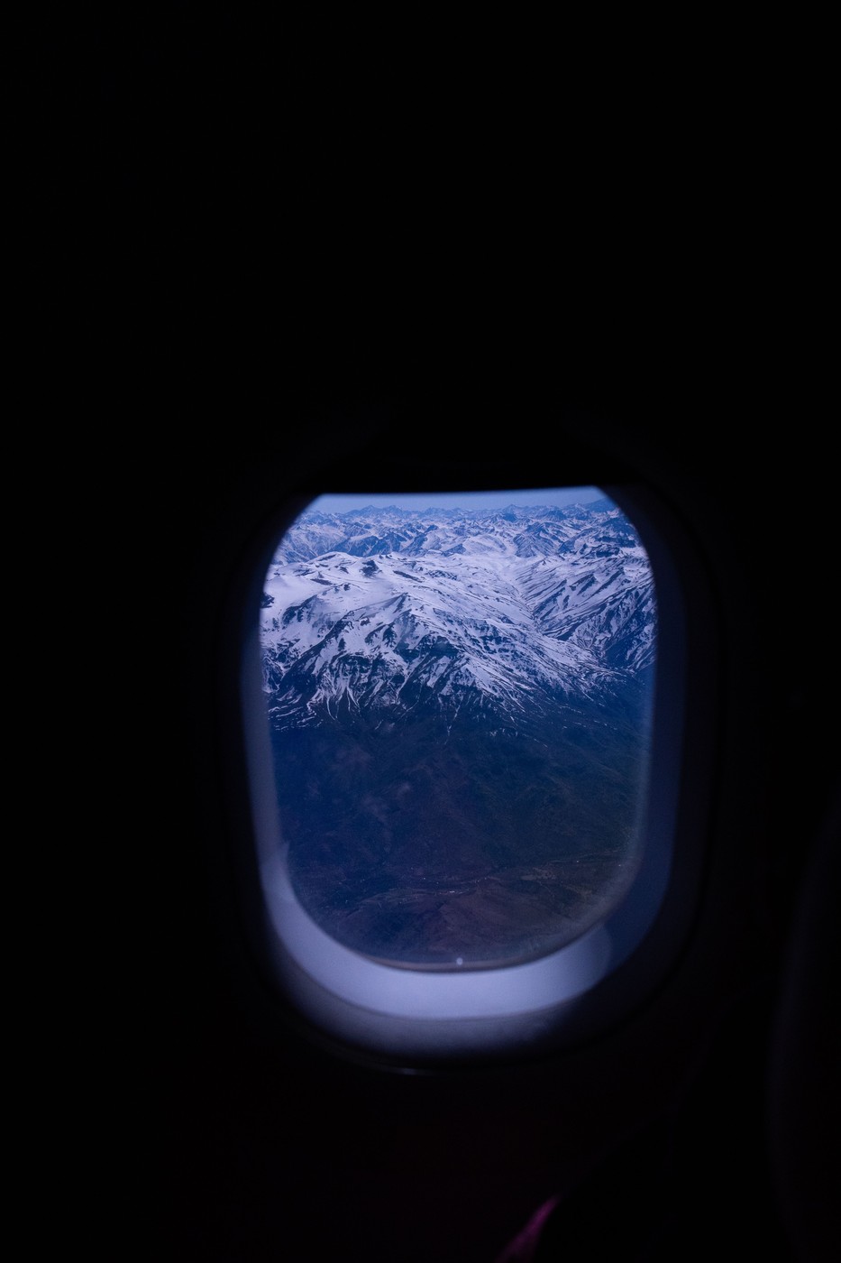 An airplane window and the bleed hole