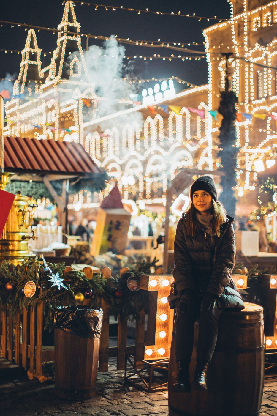 Person exploring a Christmas market alone at dusk