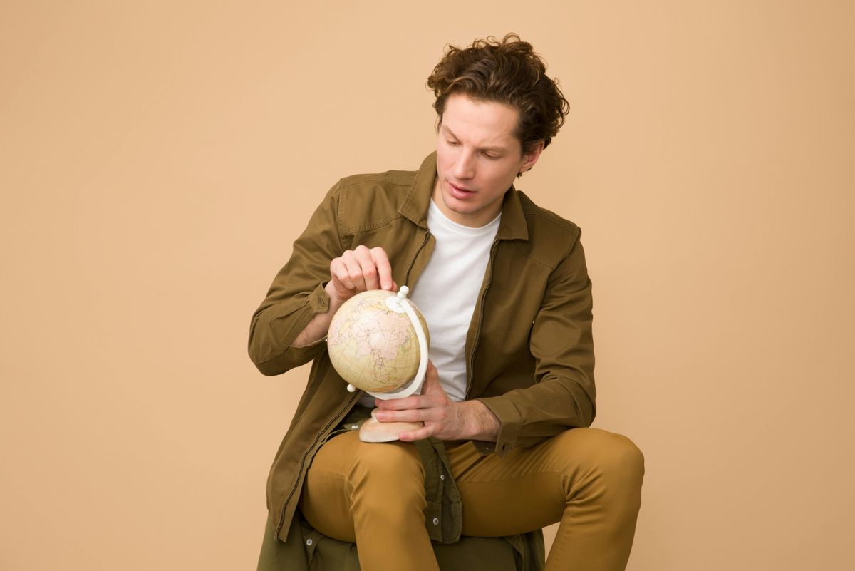 Man looking at a globe.