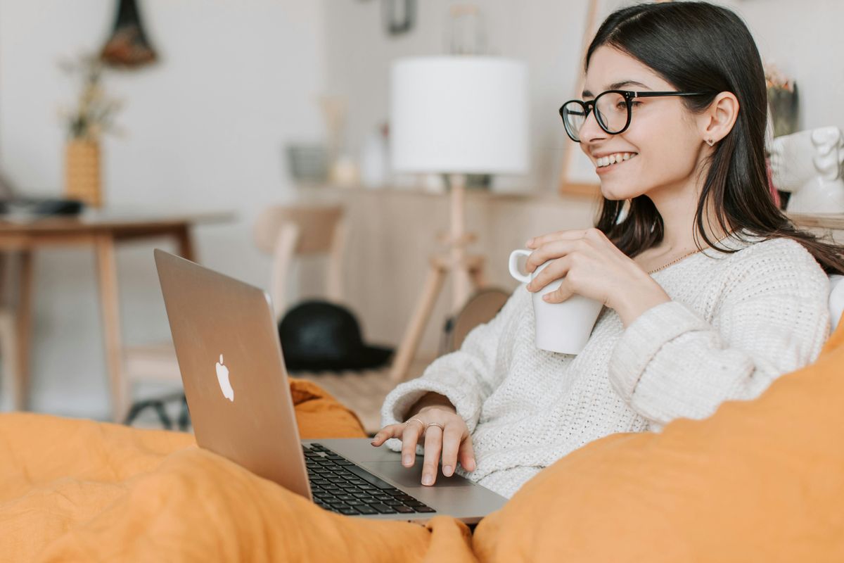 A female passenger checks in from home on her laptop