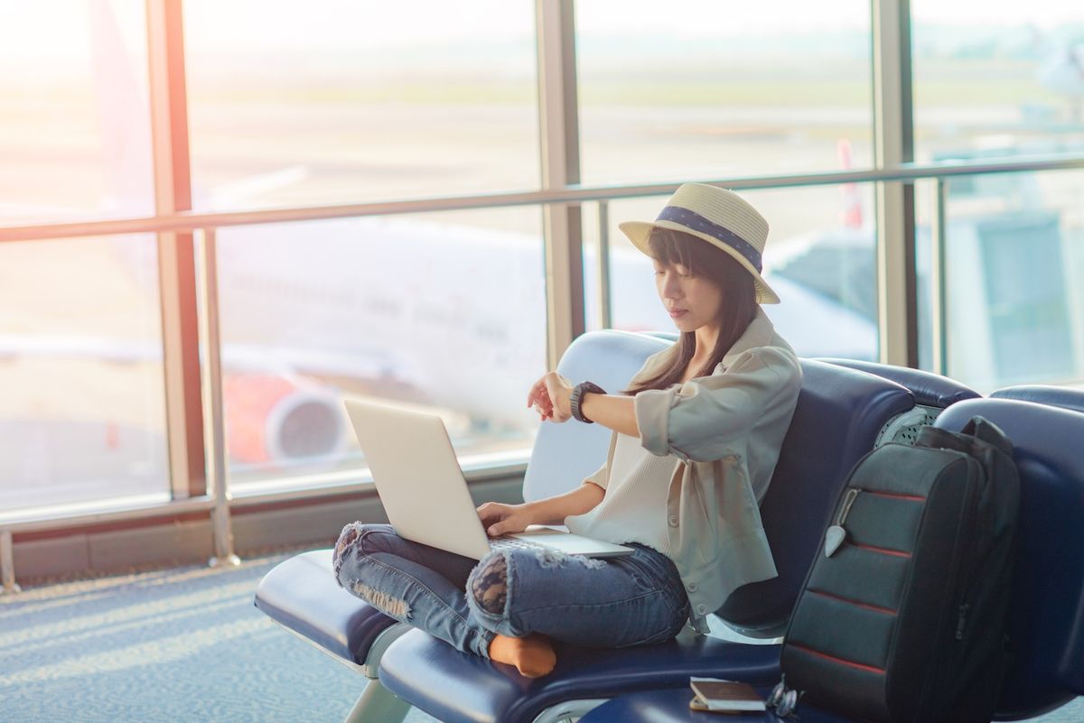 Woman checks her watch as she waits in an airport