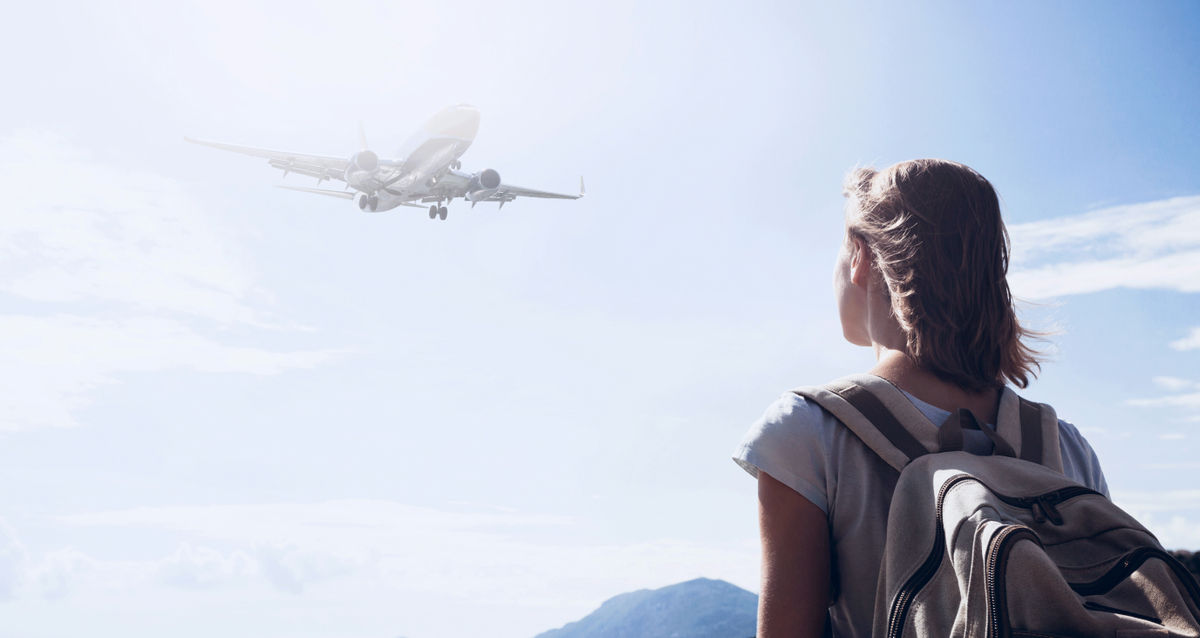A girl looking at the plane