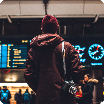 A person looking at the scoreboard at the airport