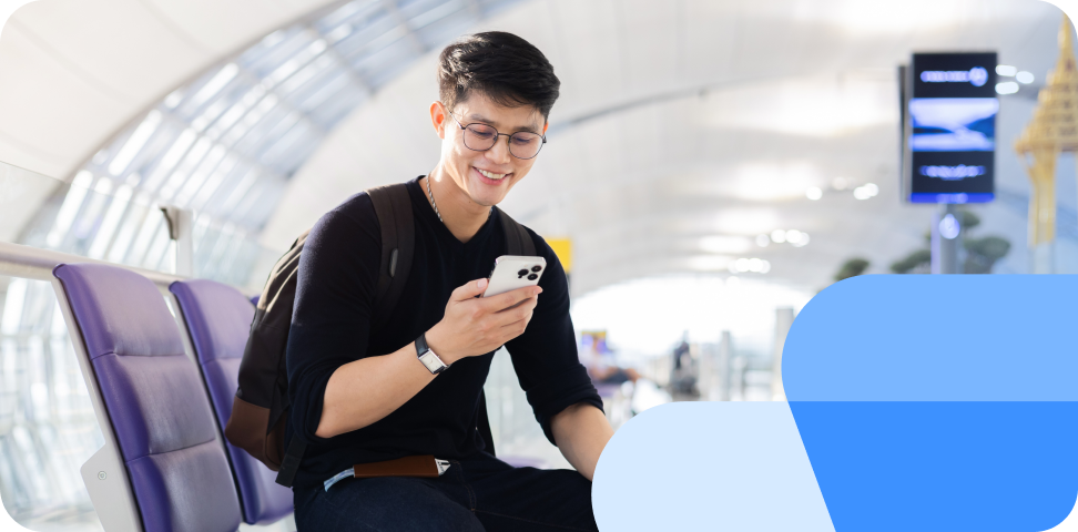 A passenger checks their air passenger rights at the airport on their phone and smiles