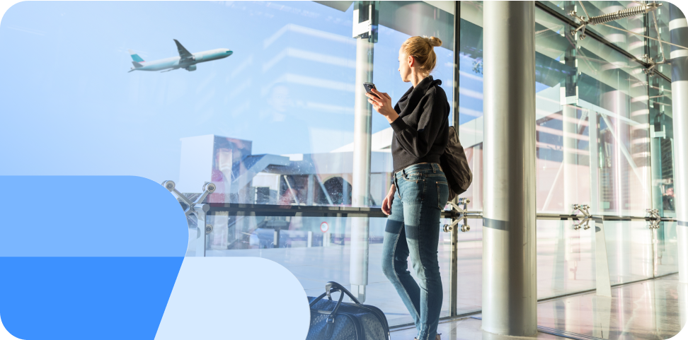 A woman checks how much flight compensation she is entitled to on her phone at an airport