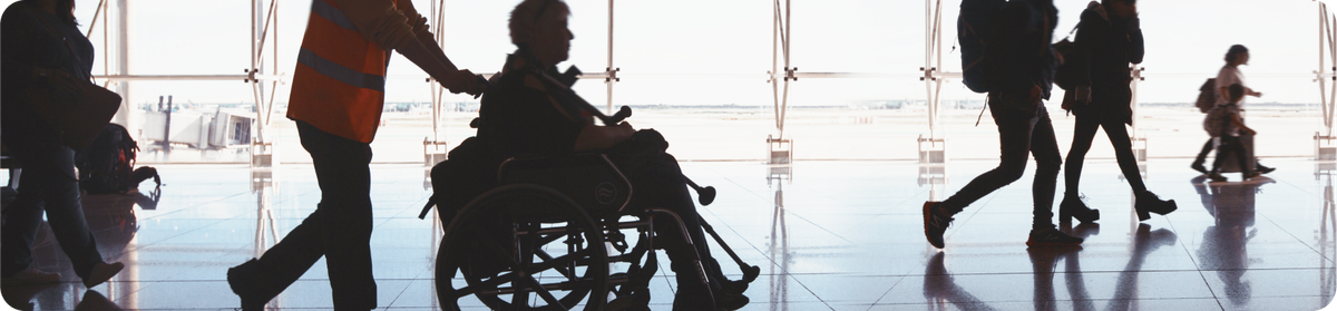 In the airport departure terminal, a passenger receives special assistance